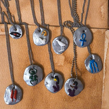 Set of necklaces with various pendants on a brown surface
