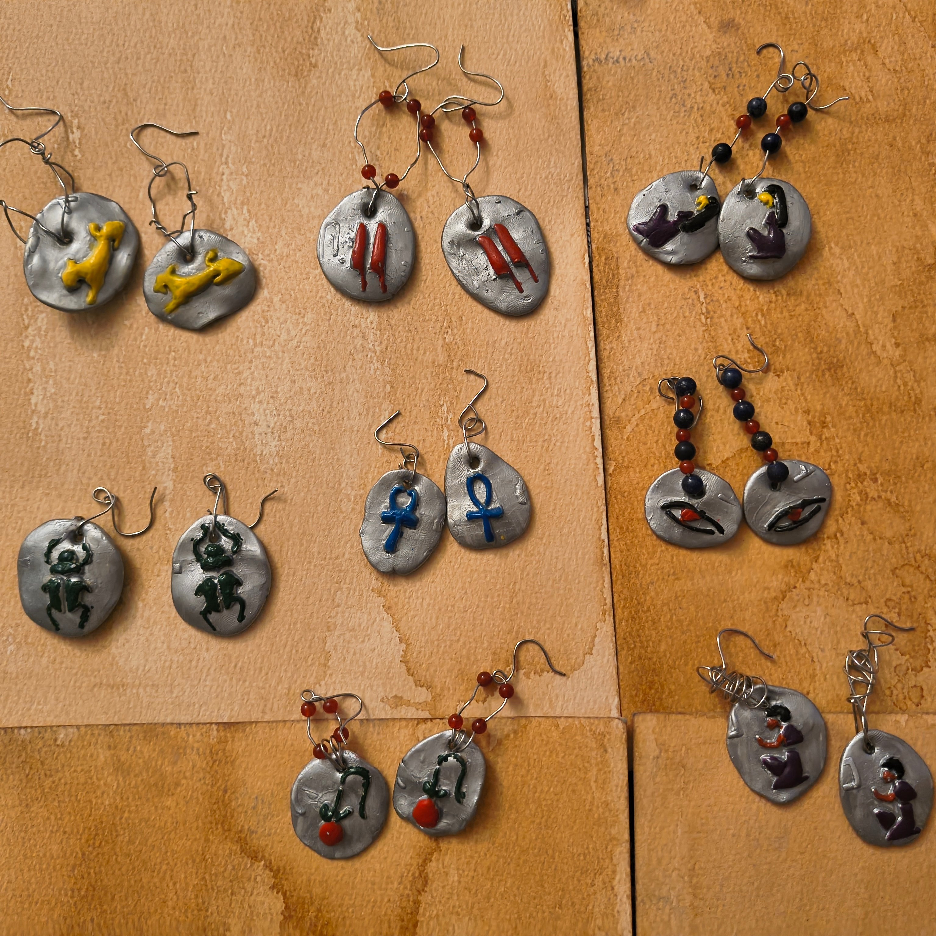 Collection of unique earrings on a brown surface