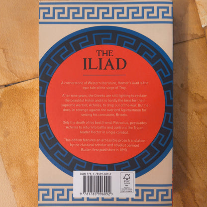 Book titled 'The Iliad' with a red circular design on a brown background